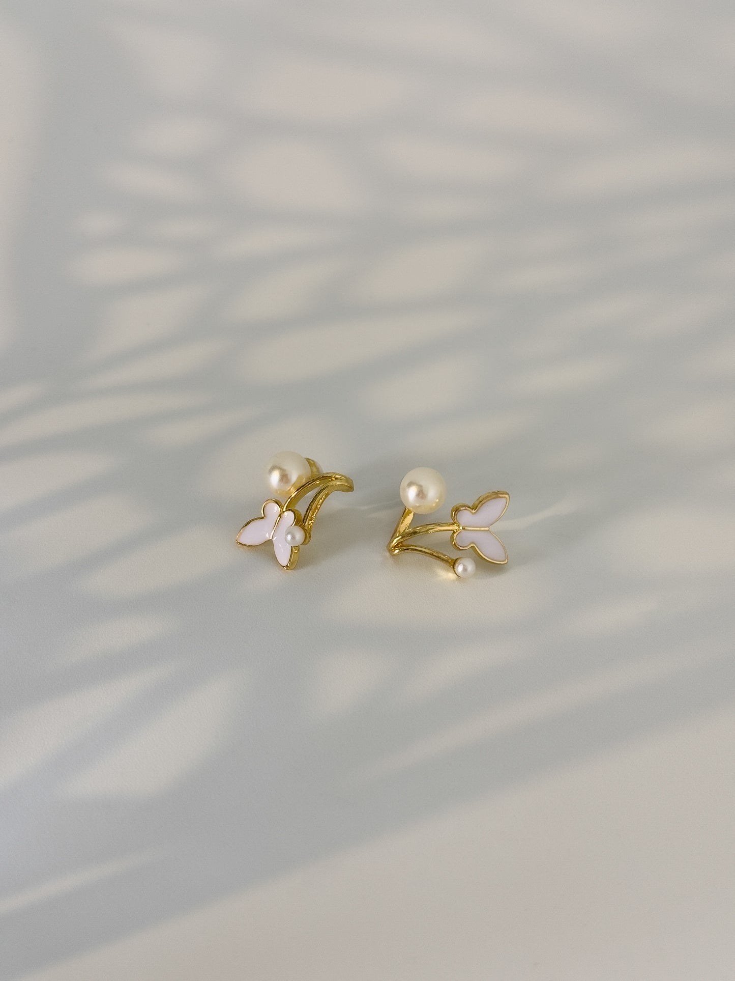 modest golden dainty earrings with a pair of pearls touch