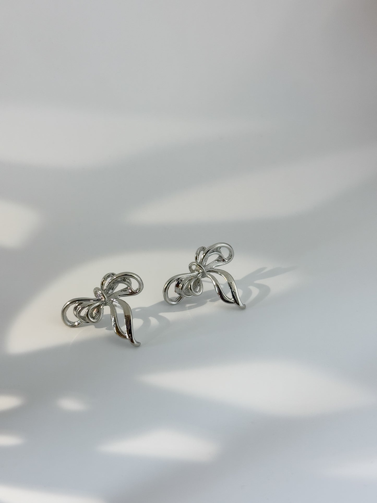 Simple silver bow-shaped earrings, modern minimal jewelry