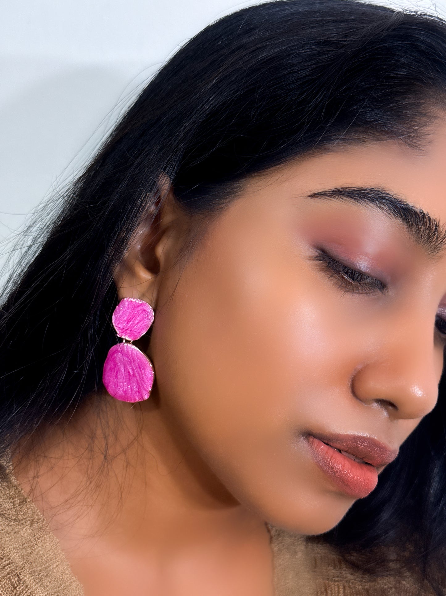 wearing earrings with a Contemporary statement styled in bright rose color pop