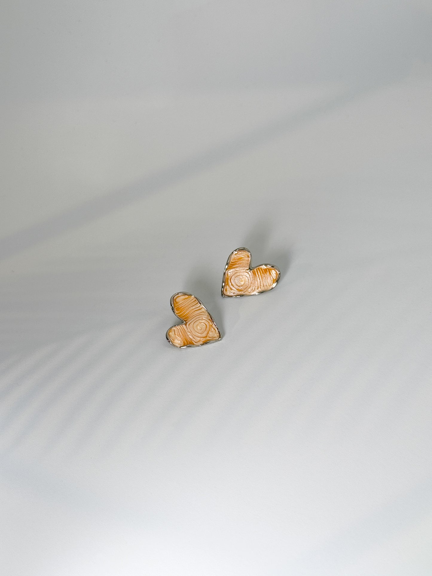 daily wear, Heart-shaped beige textured stone stud earrings with silver outline, minimal design