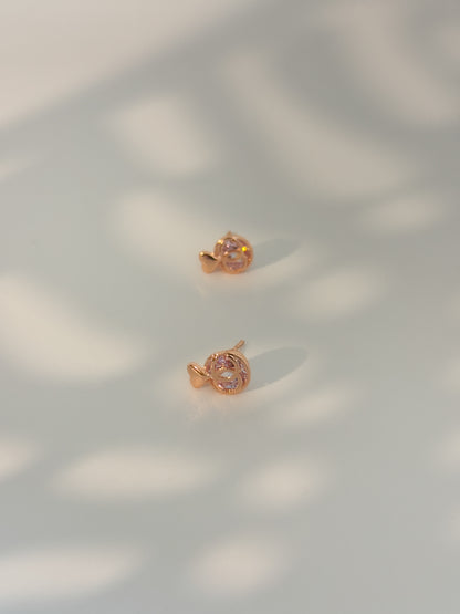 Rose gold earrings on a light background
