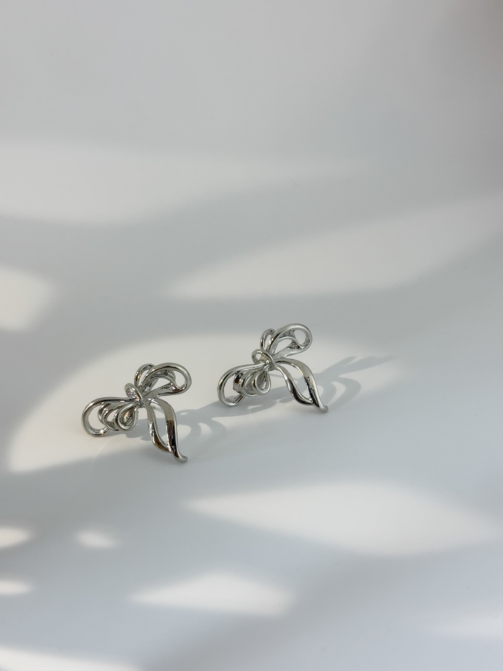 Simple silver bow-shaped earrings, modern minimal jewelry