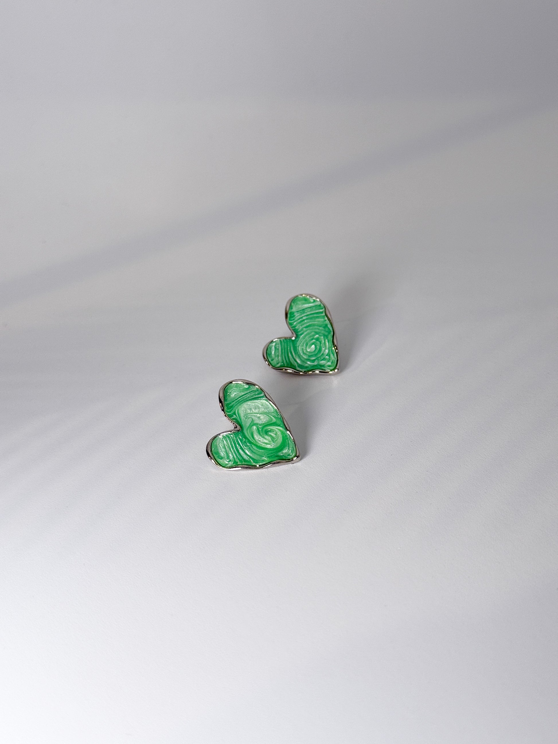 Modern fashion portrait featuring minimal green earrings