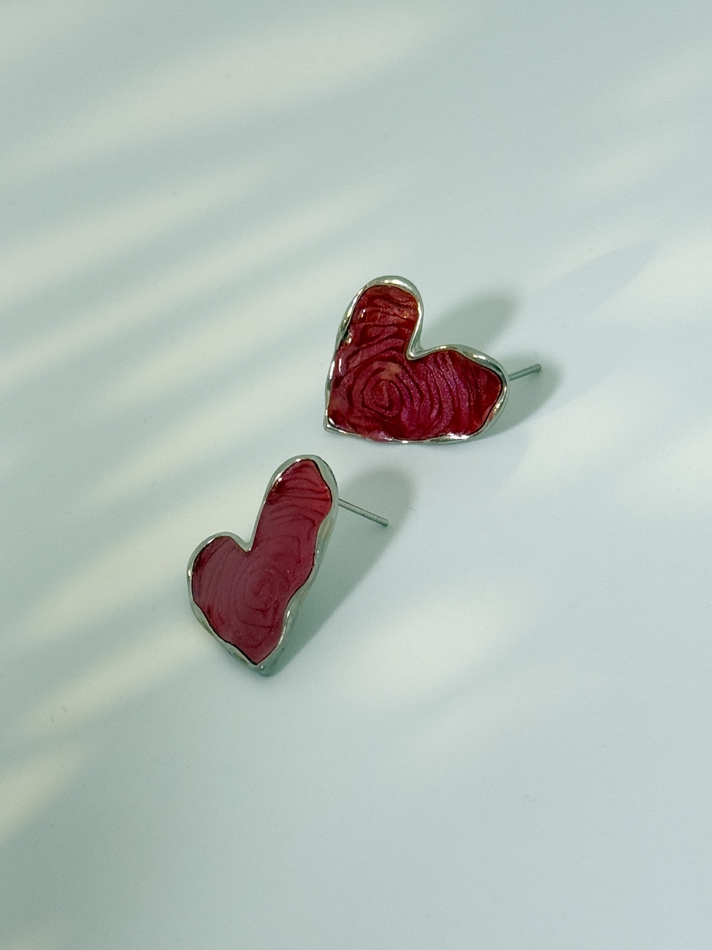 Modern fashion portrait featuring minimal maroon earrings