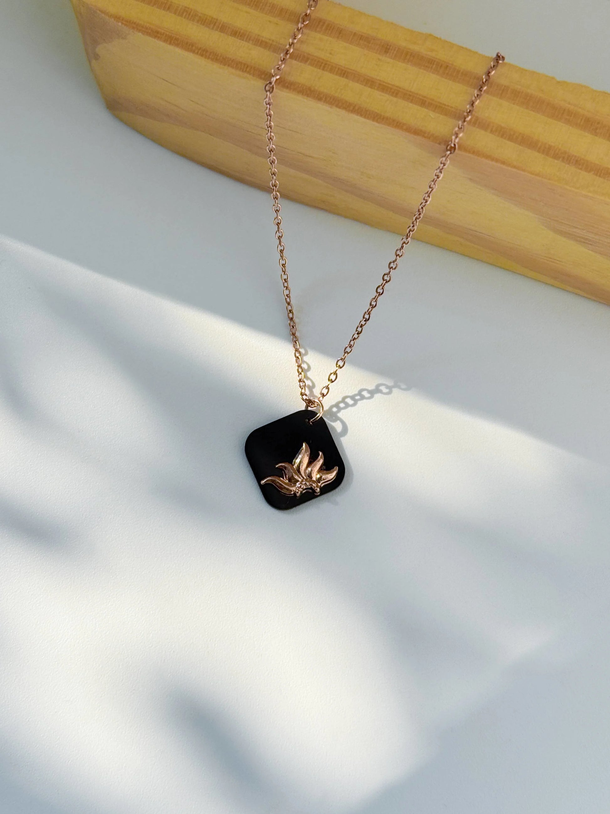 Anti Tarnish Necklace with a black pendant featuring a gold design on a light background | Minukki